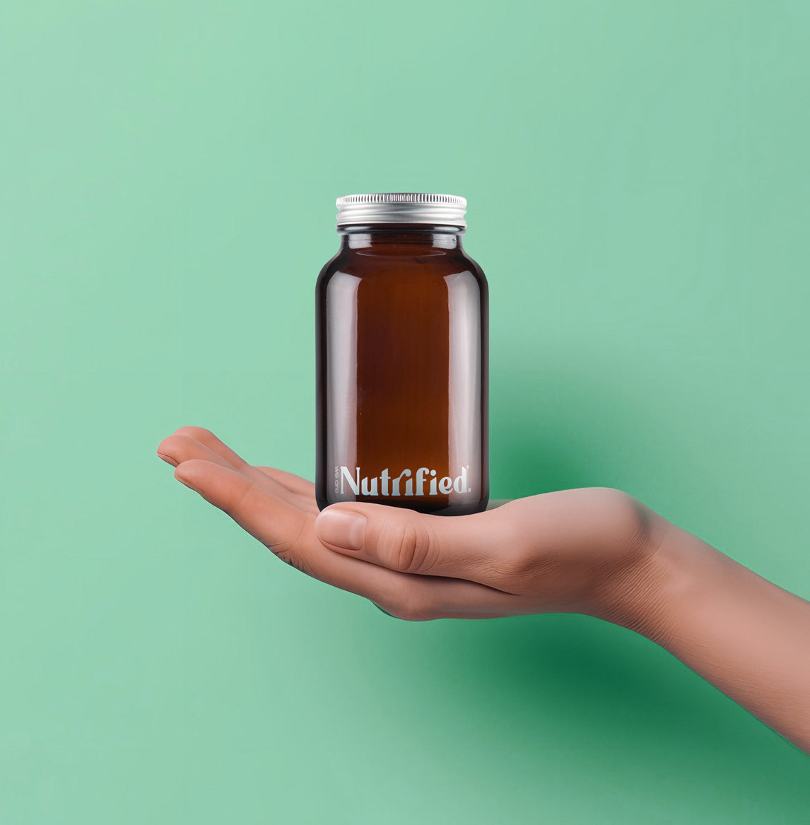 front view of hand holding Glass Jar