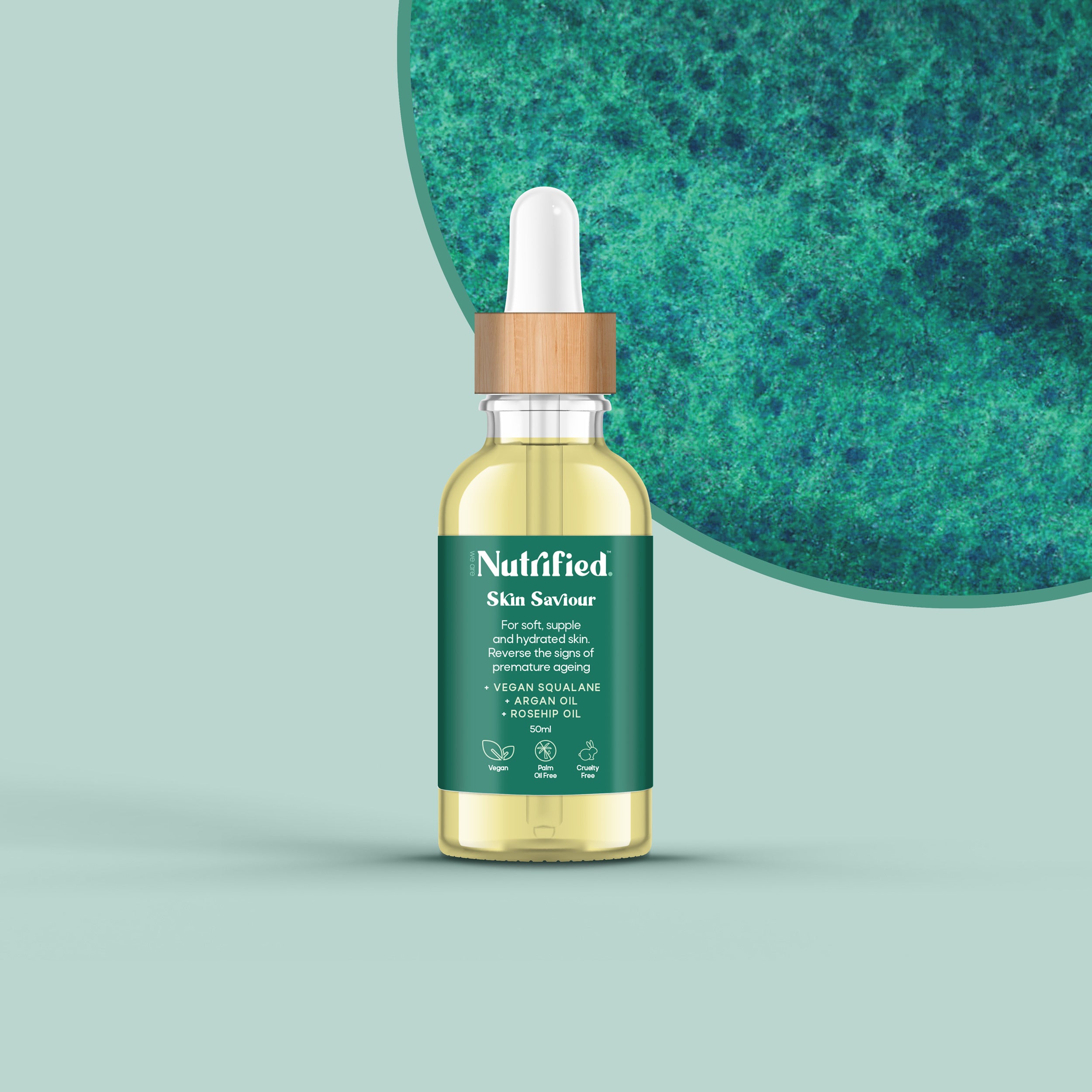 front view of Skin Saviour serum with blue/green textured background